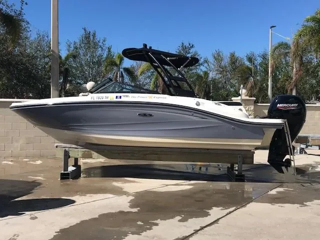 Slide: The Image of 2022 Sea Ray SPX 190 OB boat on a lift, with Mercury outboard motor. - 4