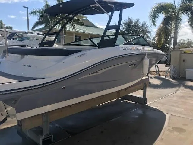Slide: The Image of 2022 Sea Ray SPX 190 boat on display with palm trees in the background. - 7