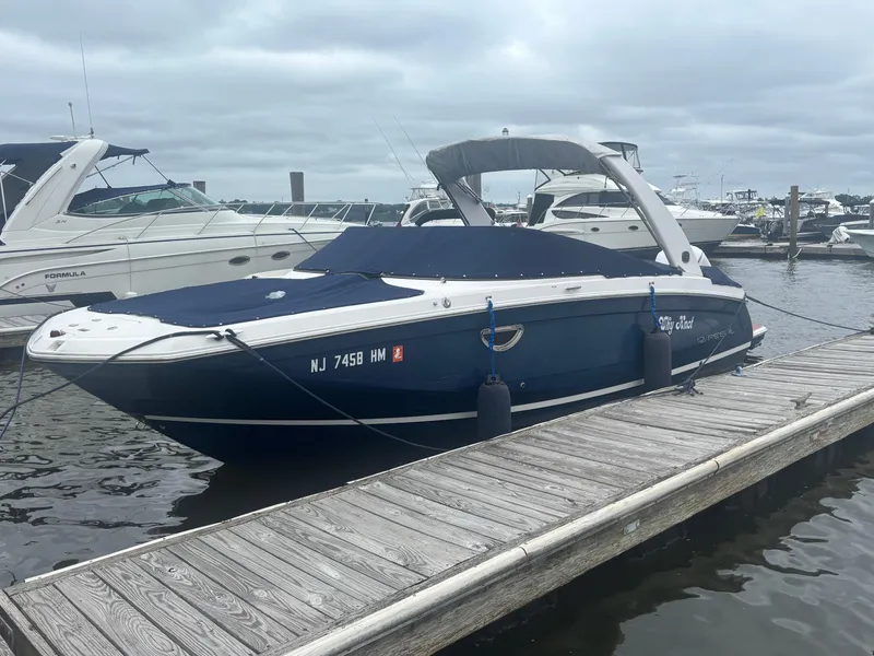 Slide: The Image of 2019 Regal 26 OBX boat docked at marina, covered and secured. - 1