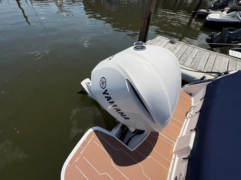 Slide: The Image of 2019 Regal 26 OBX boat with Yamaha outboard motor docked on calm water. - 14