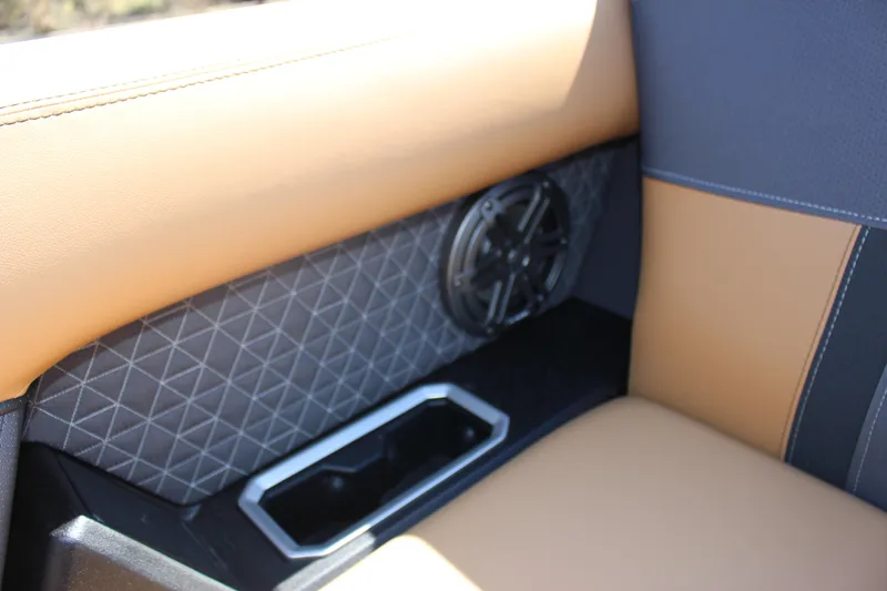 Slide: The Image of 2025 Viaggio Lago Z22S CC interior with tan and gray upholstery, speaker, and cup holder. - 8