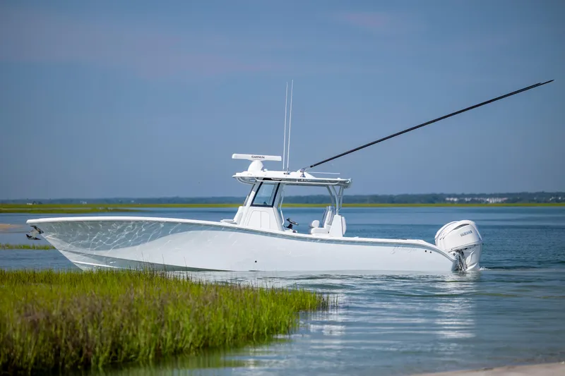 Slide: The Image of 2026 Yellowfin 36 Offshore boat in serene coastal waters. - 11