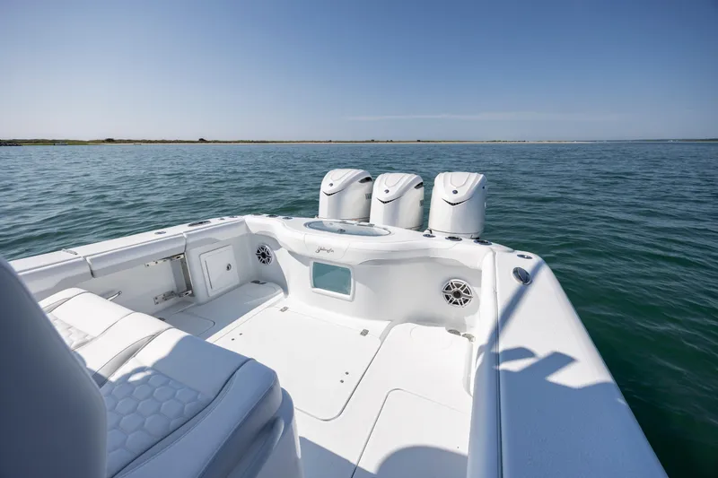 Slide: The Image of 2026 Yellowfin 36 Offshore boat on calm water, featuring triple outboard engines. - 13