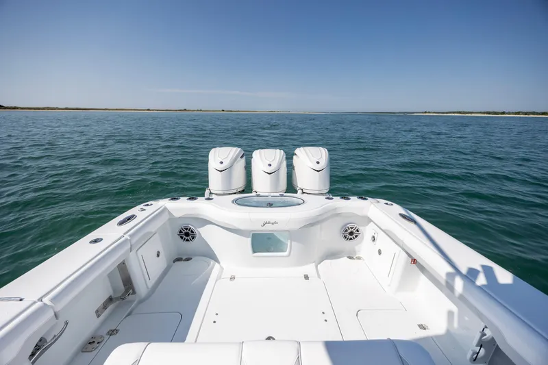 Slide: The Image of 2026 Yellowfin 36 Offshore boat on open water, featuring triple engines and spacious deck. - 14