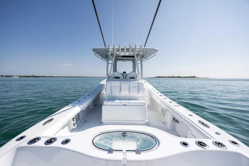 Slide: The Image of 2026 Yellowfin 36 Offshore boat on calm ocean waters under clear blue sky. - 16