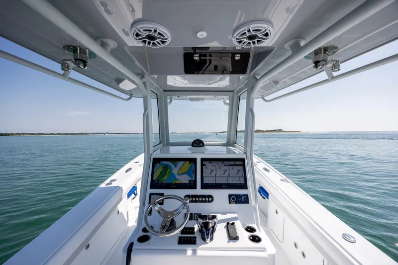 Slide: The Image of 2026 Yellowfin 36 Offshore boat dashboard with navigation screens on open water. - 18