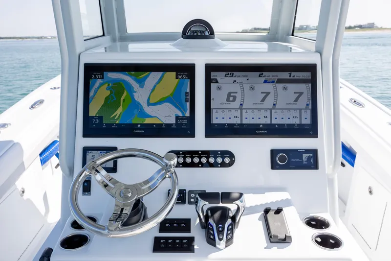 Slide: The Image of 2026 Yellowfin 36 Offshore boat dashboard with dual Garmin displays and steering wheel. - 20