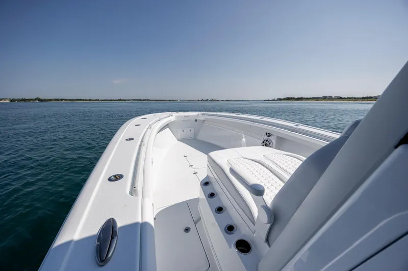 Slide: The Image of 2026 Yellowfin 36 Offshore boat on calm water, showcasing sleek design and spacious deck. - 24