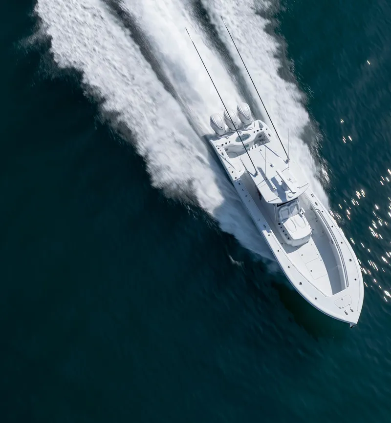 Slide: The Image of 2026 Yellowfin 36 Offshore boat speeding on open water, aerial view. - 39