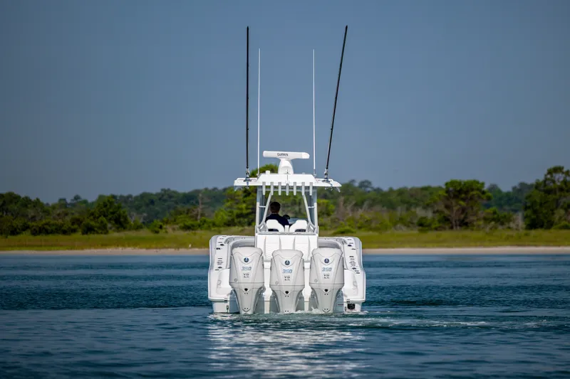 Slide: The Image of 2026 Yellowfin 36 Offshore boat with triple engines on calm water. - 4