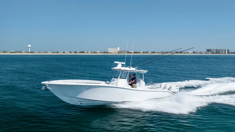 Slide: The Image of 2026 Yellowfin 36 Offshore boat cruising on open water near coastline. - 40