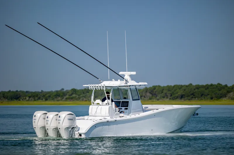 Slide: The Image of 2026 Yellowfin 36 Offshore boat cruising on calm water with triple Yamaha engines. - 6