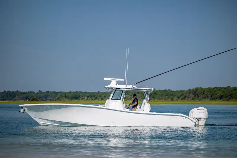 Slide: The Image of 2026 Yellowfin 36 Offshore boat cruising on calm water with clear blue sky. - 8