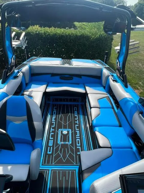 Slide: The Image of 2022 Centurion Fi23 boat interior with blue and gray seating, showcasing modern design. - 4