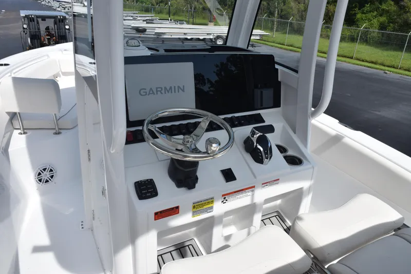 Slide: The Image of 2026 Sea Hunt Ultra 245 SE boat dashboard with Garmin navigation system and steering wheel. - 10