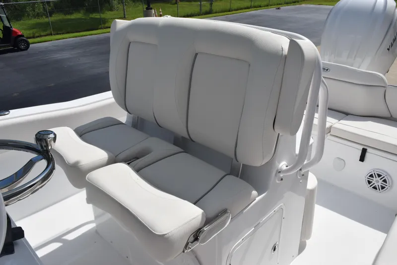 Slide: The Image of 2026 Sea Hunt Ultra 245 SE boat seating with white cushioned seats and steering wheel. - 11