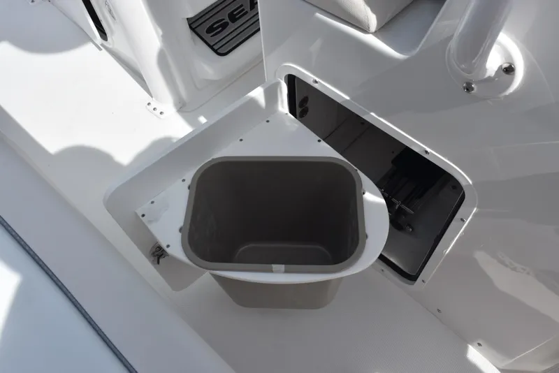 Slide: The Image of Storage compartment with trash bin on 2026 Sea Hunt Ultra 245 SE boat. - 18