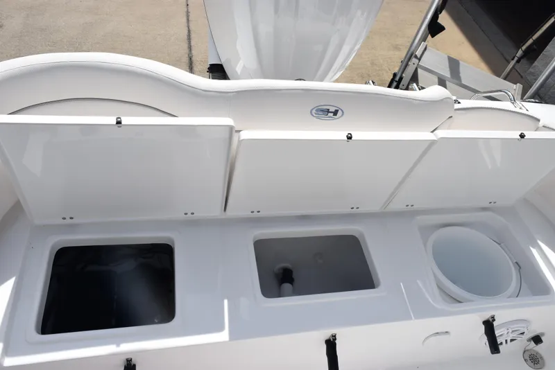 Slide: The Image of 2026 Sea Hunt Ultra 245 SE boat storage compartments and seating area. - 22