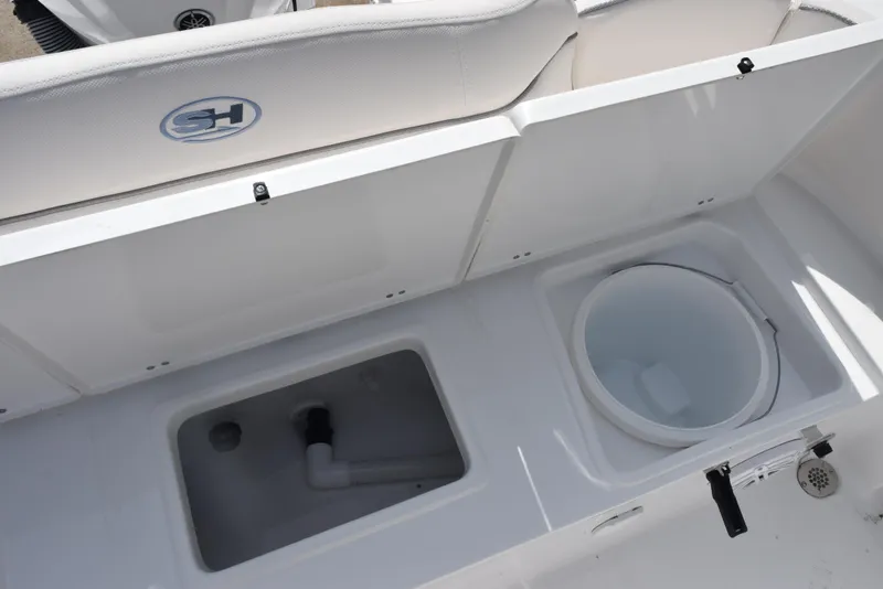 Slide: The Image of 2026 Sea Hunt Ultra 245 SE boat storage compartments and seating detail. - 23