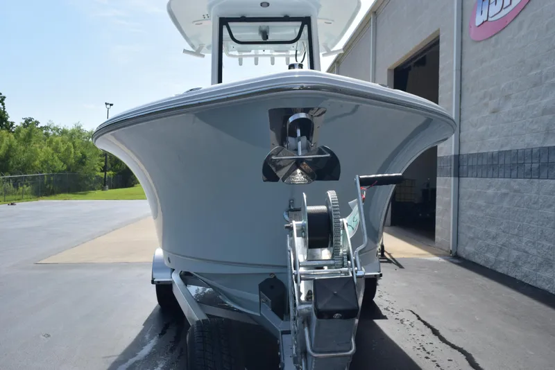 Slide: The Image of 2026 Sea Hunt Ultra 245 SE boat on trailer, parked outside a building. - 3