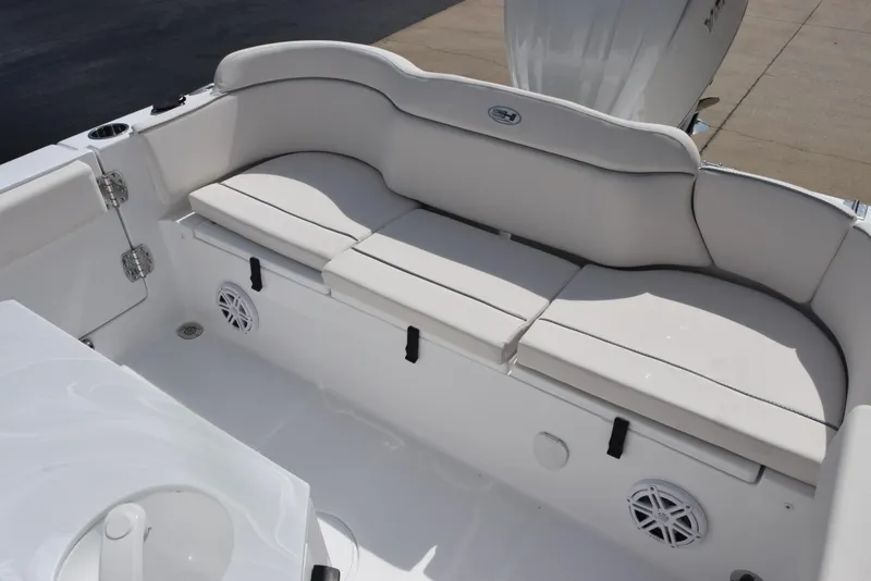Slide: The Image of 2026 Sea Hunt Ultra 245 SE boat interior with cushioned seating and storage. - 9
