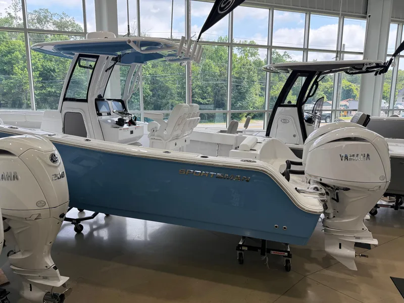 Slide: The Image of 2025 Sportsman Open 252 Center Console boat with Yamaha engines in showroom. - 0
