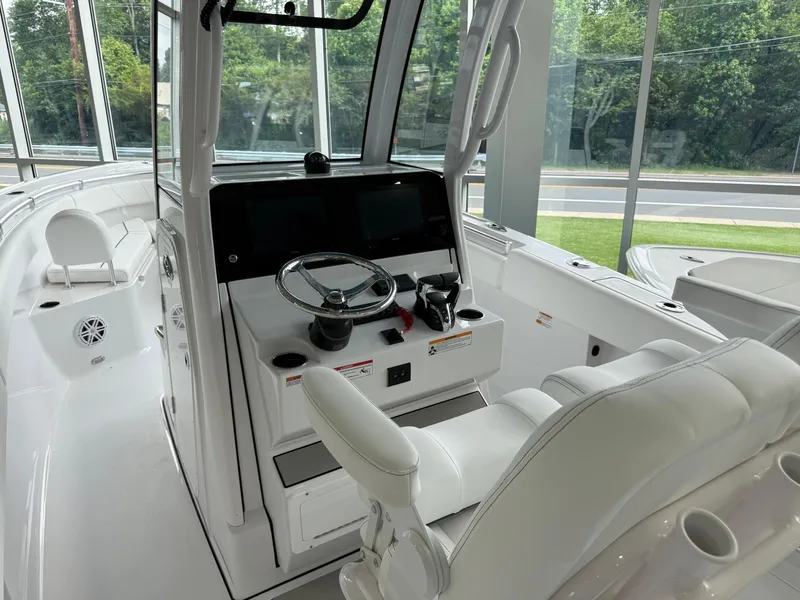 Slide: The Image of 2025 Sportsman Open 252 Center Console boat interior with modern helm and seating. - 2