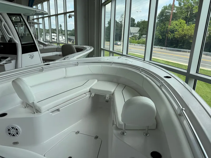 Slide: The Image of 2025 Sportsman Open 252 Center Console boat interior with white seating and modern design. - 7