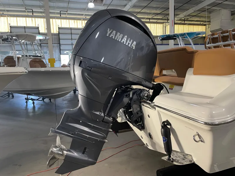 Slide: The Image of 2025 Key West 203 FS boat with Yamaha outboard motor in a showroom. - 12