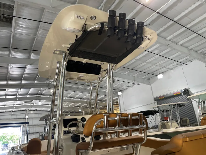 Slide: The Image of 2025 Key West 203 FS boat interior with T-top and rod holders in a showroom. - 13