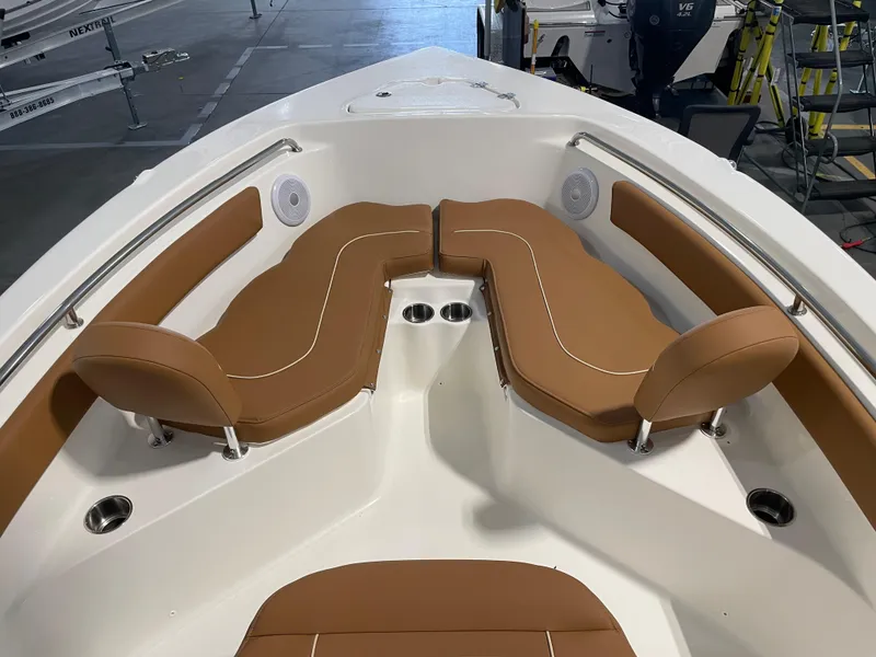 Slide: The Image of 2025 Key West 203 FS boat interior with tan seating and cup holders. - 16