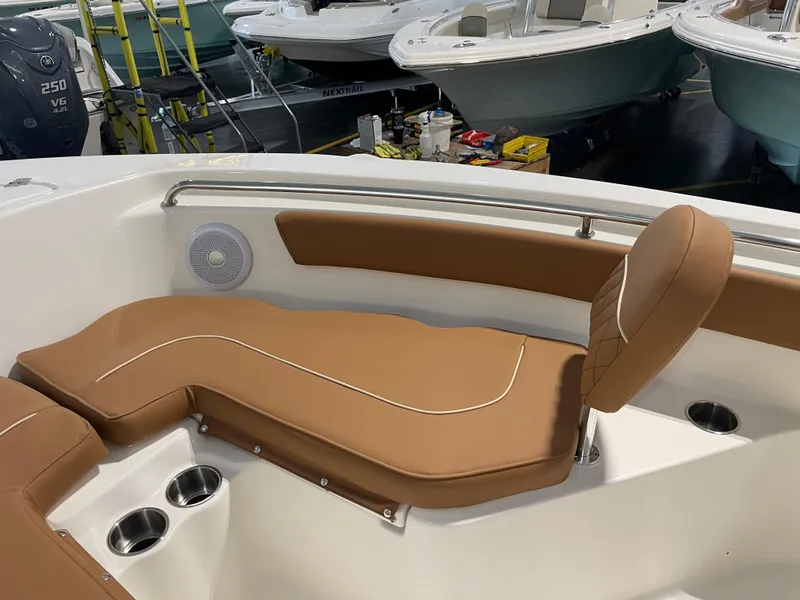 Slide: The Image of 2025 Key West 203 FS boat interior with tan seating and cup holders. - 18