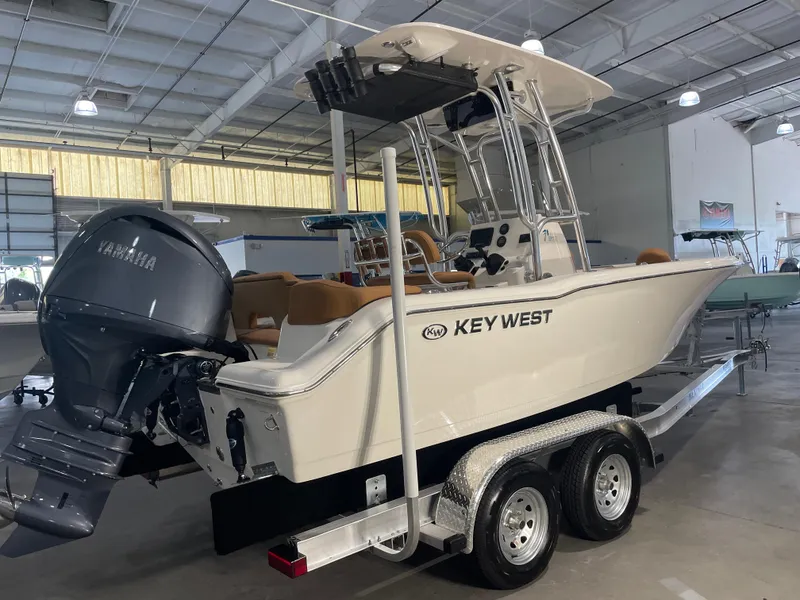 Slide: The Image of 2025 Key West 203 FS boat with Yamaha engine on trailer in showroom. - 2