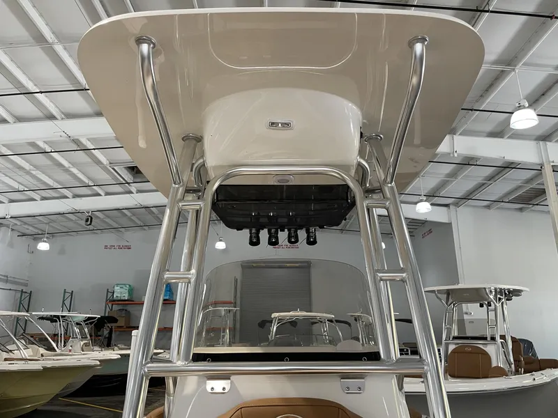 Slide: The Image of 2025 Key West 203 FS boat in showroom, featuring sleek design and sturdy T-top. - 22