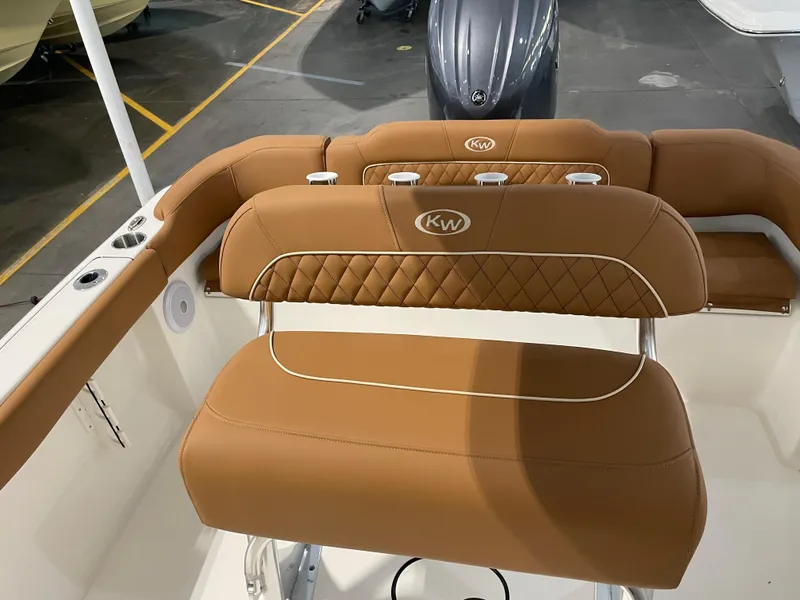 Slide: The Image of 2025 Key West 203 FS boat interior with tan leather seating and KW logo. - 25