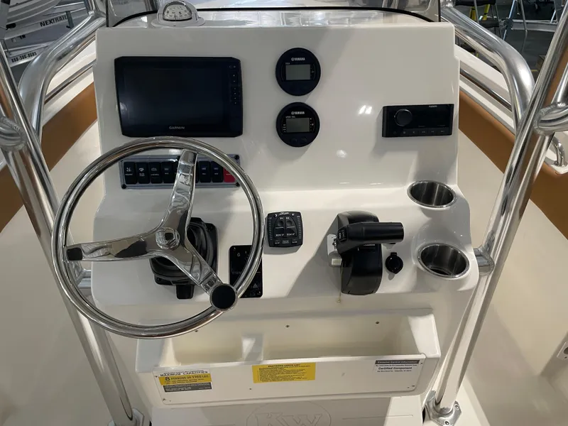 Slide: The Image of 2025 Key West 203 FS boat console with steering wheel, gauges, and controls. - 26