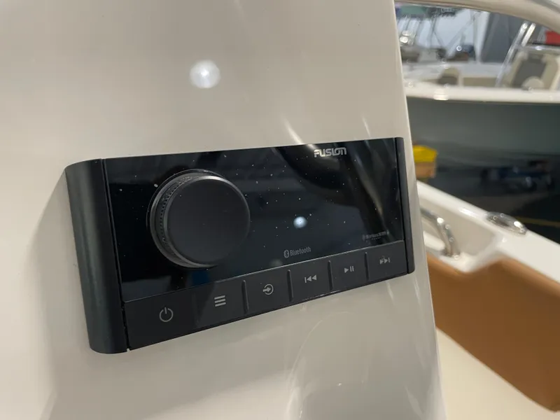 Slide: The Image of Control panel on 2025 Key West 203 FS boat, featuring Fusion audio system with Bluetooth connectivity. - 29