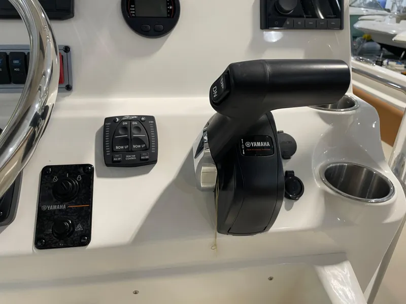 Slide: The Image of Control panel of 2025 Key West 203 FS boat with Yamaha throttle and steering wheel. - 30