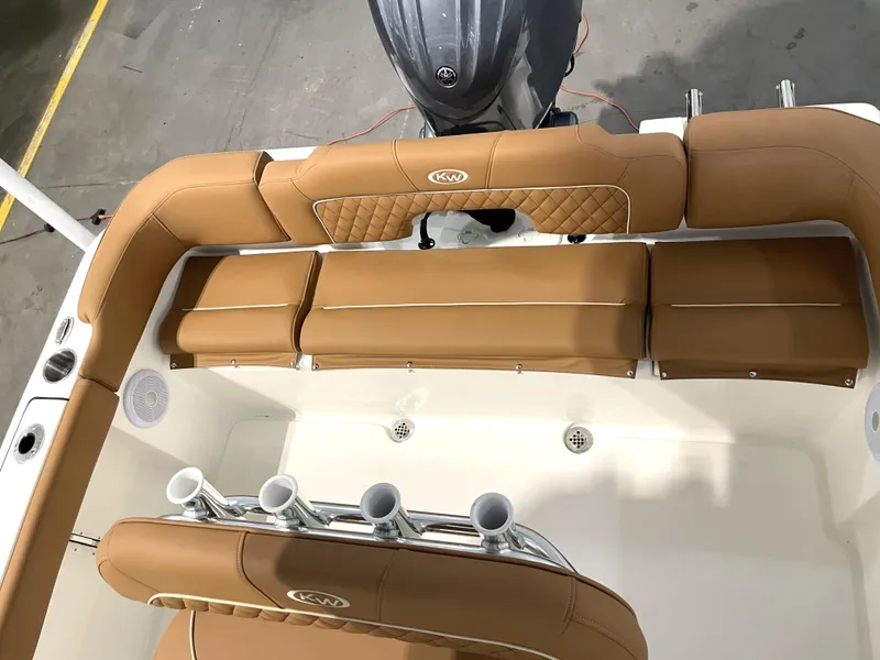 Slide: The Image of 2025 Key West 203 FS boat interior with tan seating and rod holders. - 33
