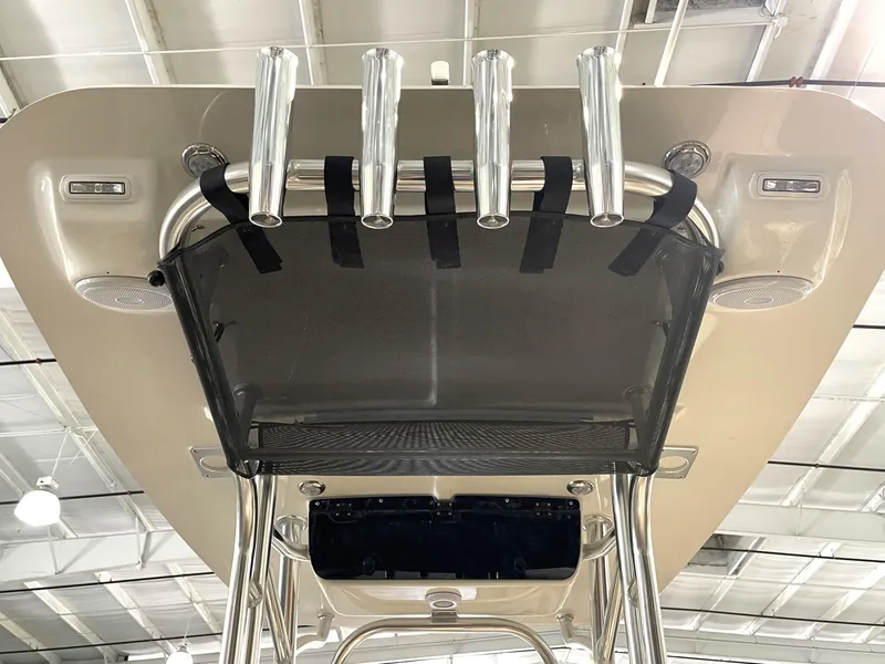 Slide: The Image of 2025 Key West 203 FS boat T-top with rod holders and speakers in a showroom. - 34