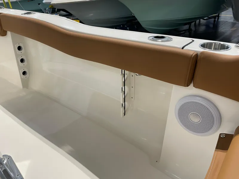 Slide: The Image of 2025 Key West 203 FS boat interior with tan seating and built-in speaker. - 35
