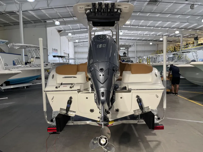 Slide: The Image of 2025 Key West 203 FS boat in showroom, featuring powerful outboard motor. - 8