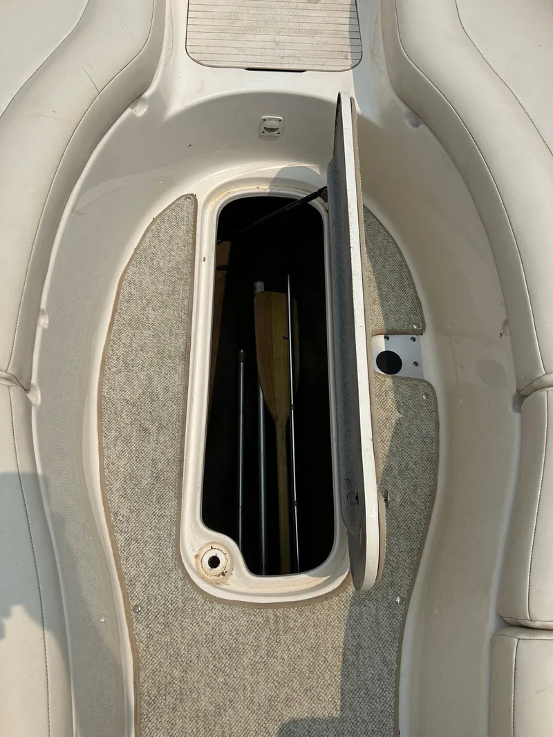 Slide: The Image of 2000 Chaparral Sunesta 233 boat interior with white seating and blue accents. - 10