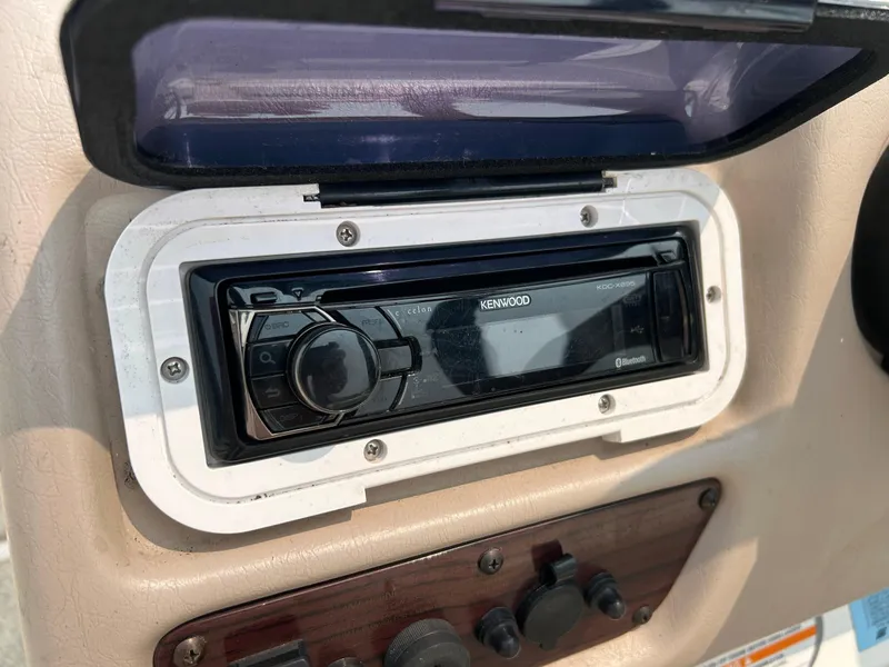 Slide: The Image of 2000 Chaparral Sunesta 233 boat with green cover. - 22