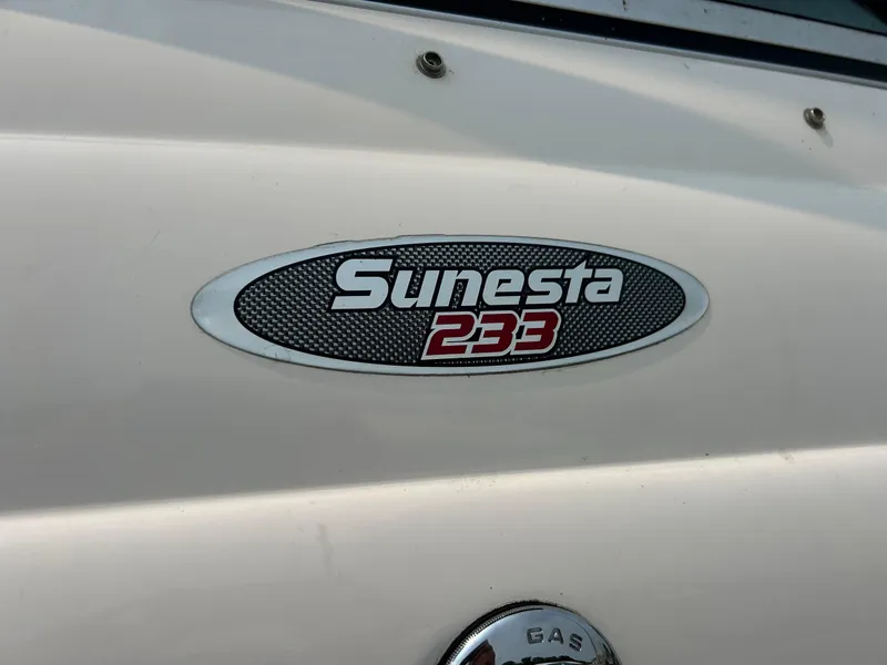 Slide: The Image of 2000 Chaparral Sunesta 233 boat interior with white and blue seating. - 34