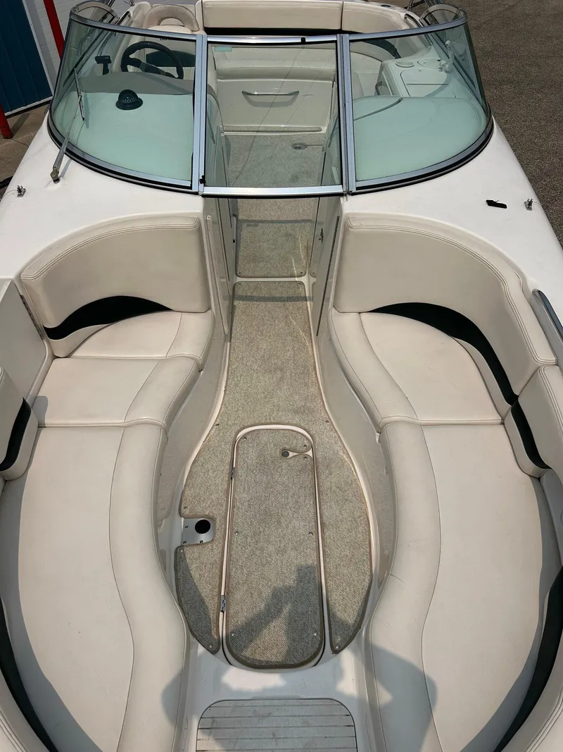 Slide: The Image of Chaparral Sunesta 233 2000 boat seat with white upholstery and blue accent stripe. - 40