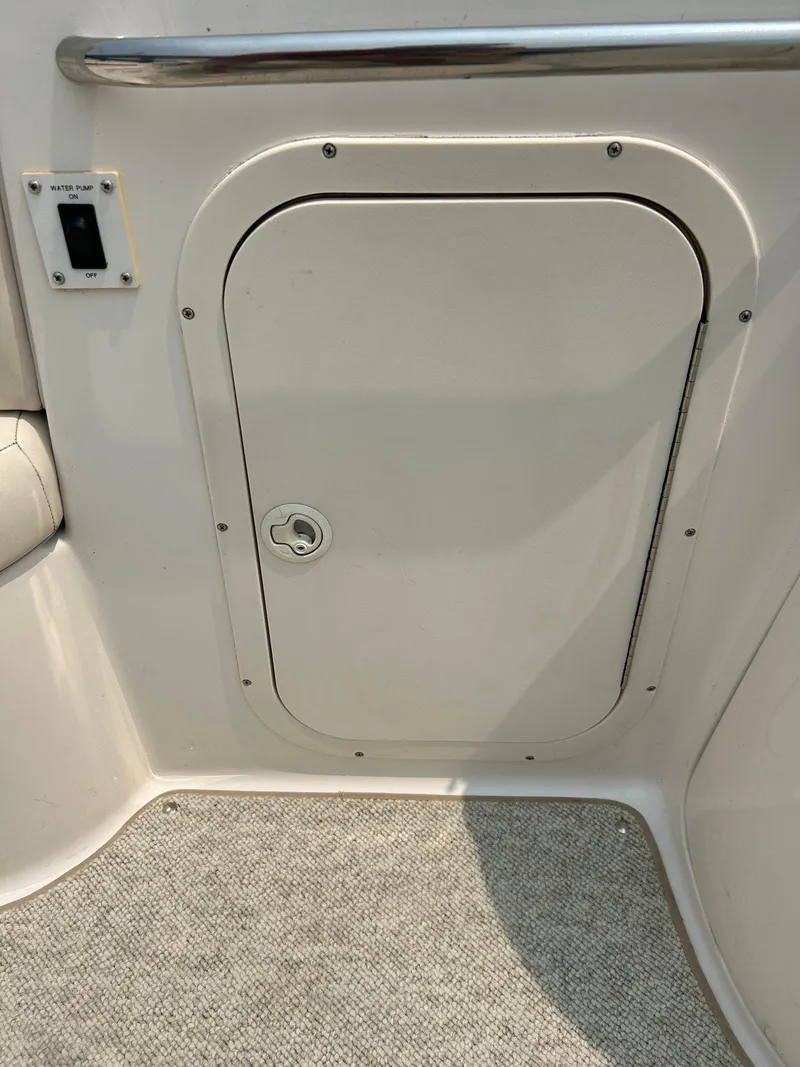 Slide: The Image of 2000 Chaparral Sunesta 233 boat interior with white seating and cup holders. - 42