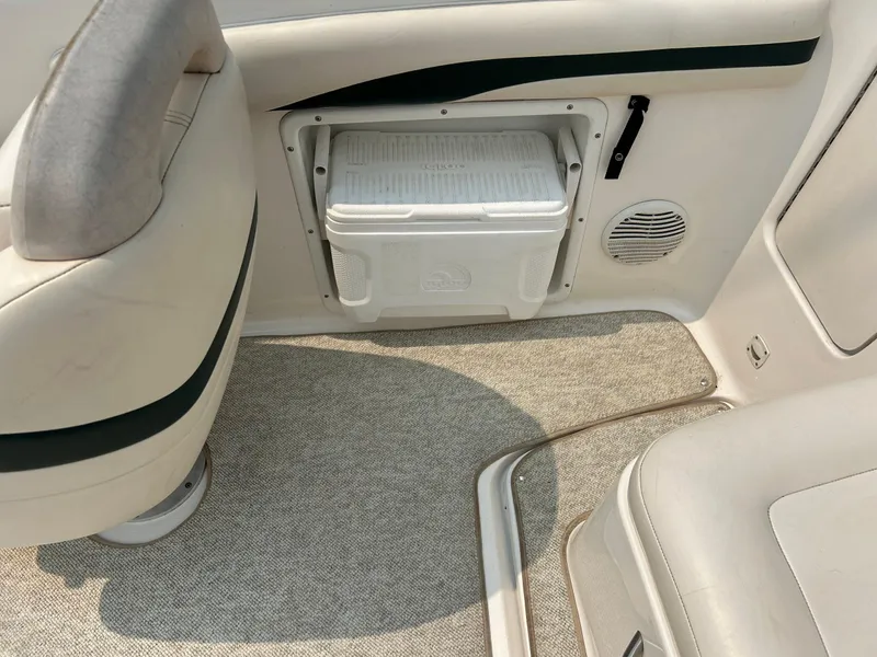 Slide: The Image of 2000 Chaparral Sunesta 233 boat dashboard with gauges and storage compartment. - 44