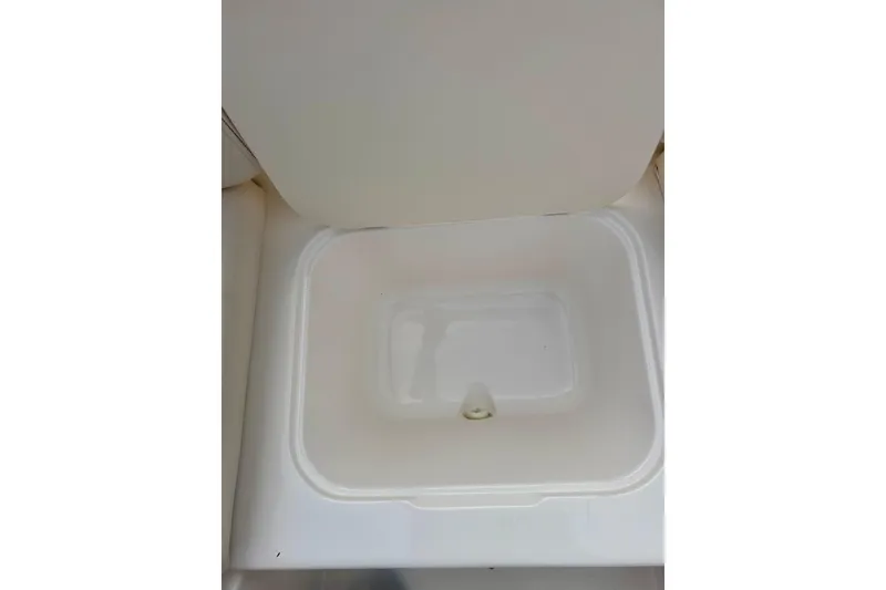 Slide: The Image of Storage compartment in 2000 Chaparral Sunesta 233 boat, open lid view. - 53