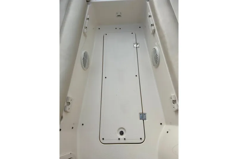 Slide: The Image of 2000 Chaparral Sunesta 233 boat interior with storage compartment and speakers. - 54
